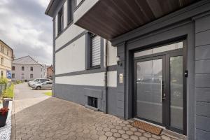 a gray and white building with a door at Ferienwohnung 2 in Bad Salzuflen