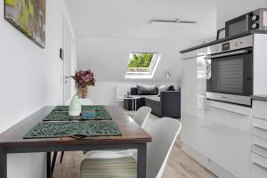 a kitchen and living room with a table and chairs at Ferienwohnung 2 in Bad Salzuflen