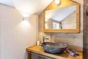 a bathroom with a stone sink and a mirror at Hof Rosenstein in Helle +75 photos