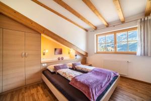 a bedroom with a bed and a window at Feldhof Apartment Apfeltraum in Caines +21 photos