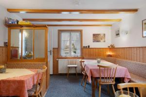 a dining room with two tables and a window at Haus Luise in Lenzkirch in Lenzkirch