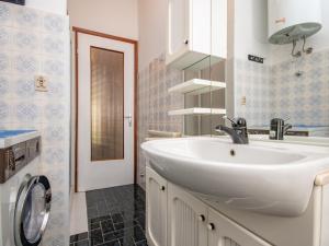a bathroom with a white sink and a mirror at Casa Camilla in Manerba del Garda +21 photos