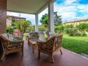 a porch with two chairs and a table at Casa Camilla in Manerba del Garda