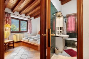 a bedroom with a bed and a sink and a mirror at Au Petit Chevrot - Classic in Aosta +62 photos