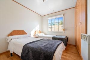 two beds in a room with a window at La Marquesa in Camarles +30 photos