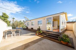 a home with a large patio with a table at La Marquesa in Camarles