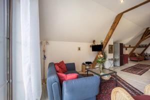 a living room with a couch and a table at Ferienwohnung im Haus Kreuzthal in Buchenberg +9 photos
