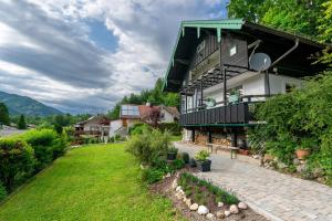 a large house with a green roof and a yard at Haus Ruheplatzerl in Ruhpolding