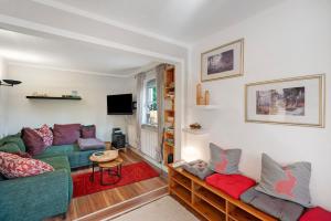 a living room with a couch and a table at Haus Ruheplatzerl in Ruhpolding