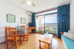 a living room with a couch and a table and a window at Apartamento residencial Fénix in Roquetas de Mar