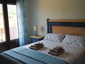 a bedroom with a bed with two towels on it at El Cierzo de Sediles in Sediles