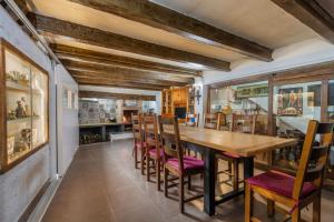 a dining room with a wooden table and chairs at El Cierzo de Sediles in Sediles