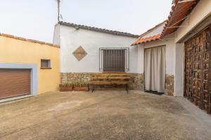 a wooden bench sitting in front of a building at El Cierzo de Sediles in Sediles