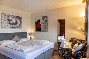 a hotel room with a bed and a chair at Haus Excelsior Top 36 in Seefeld in Tirol