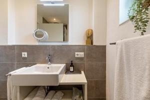 a bathroom with a sink and a mirror at Fewo Parkside S3 - 8Min Legoland in Günzburg +18 photos