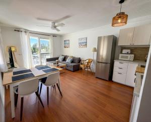 a kitchen and living room with a table and a refrigerator at Casa Blanca in Torrox Costa