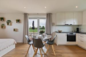 a kitchen and dining room with a table and chairs at Fewo Parkside S3 - 8Min Legoland in Günzburg