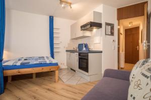 a small kitchen with a bed in a room at Ferienwohnung Förster in Überlingen