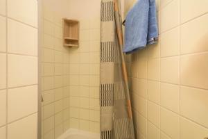 a shower with a shower curtain in a bathroom at Ferienwohnung Förster in Überlingen +11 photos