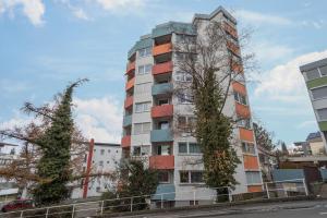a tall building with trees on the side of it at Ferienwohnung Förster in Überlingen