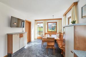 a kitchen and dining room with a table and chairs at Blasigsuite Blasighof in Racines +26 photos