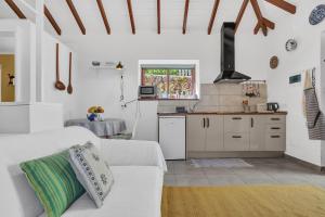 a living room with a white couch and a kitchen at Casa de Teja in La Orotava