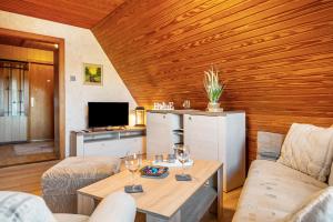 a living room with a couch and a table at Ferienwohnung Anne in Bremervörde