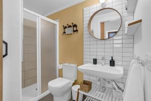 a bathroom with a toilet and a sink and a mirror at Casa de Teja in La Orotava +18 photos