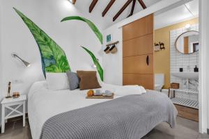 a bedroom with a bed and a bathroom with a sink at Casa de Teja in La Orotava