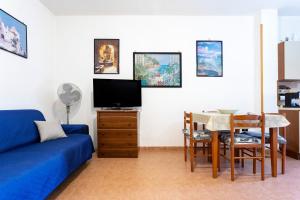a living room with a blue couch and a table at Dimora Giusy in Otranto