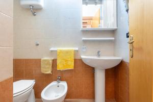 a bathroom with a sink and a toilet and a mirror at Dimora Giusy in Otranto +12 photos
