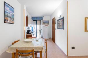 a kitchen and dining room with a table and chairs at Dimora Giusy in Otranto