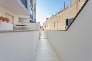 an alley between two buildings with an umbrella at Dimora Giusy in Otranto