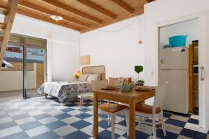 a kitchen and living room with a table and a refrigerator at Blue Oasis in El Cotillo