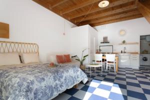 a bedroom with a bed and a table and a kitchen at Blue Oasis in El Cotillo +17 photos