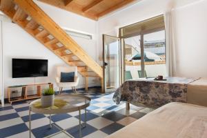 a bedroom with a bed and a table and a tv at Blue Oasis in El Cotillo