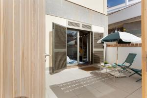 a patio with a table and an umbrella at Blue Oasis in El Cotillo