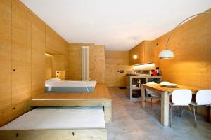 a bedroom with a bed and a table and chairs at Secret Place - Pila Appartamenti in Pila