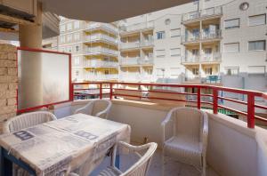 a table and chairs on the balcony of a building at Navgts5p33-1 in Torrevieja