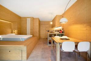 a bedroom with a bed and a table and chairs at Secret Place - Pila Appartamenti in Pila +15 photos