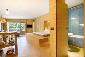 a bedroom with a bed and a tub and a sink at Secret Place - Pila Appartamenti in Pila