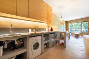 a kitchen with a sink and a washing machine at Secret Place - Pila Appartamenti in Pila