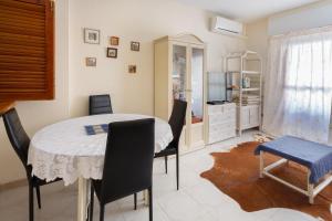 a dining room with a table and chairs at Navgts5p33-1 in Torrevieja +14 photos