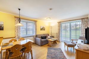a living room with a couch and a table at Fewo Brünnstein - Zimmer 6 in Oberaudorf