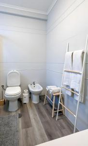 a white bathroom with a toilet and a sink at Costa Nova Ocean View in Gafanha da Encarnação +24 photos