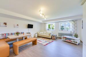 a living room with a couch and a table at Fewo Trudi in Grabenstätt