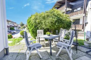 a table and four chairs on a patio at Fewo Trudi in Grabenstätt