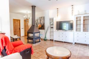 a living room with a fireplace and a tv at Casa Jema in Torrox