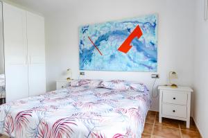 a bedroom with a bed and a painting on the wall at Casa Jema in Torrox +15 photos