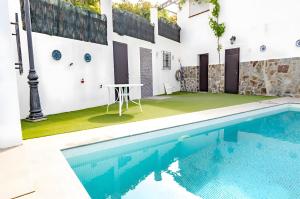 a pool with a table next to a building at Casa Jema in Torrox